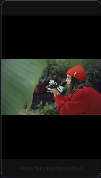 A person composing a shot with a camera, from the revised course.